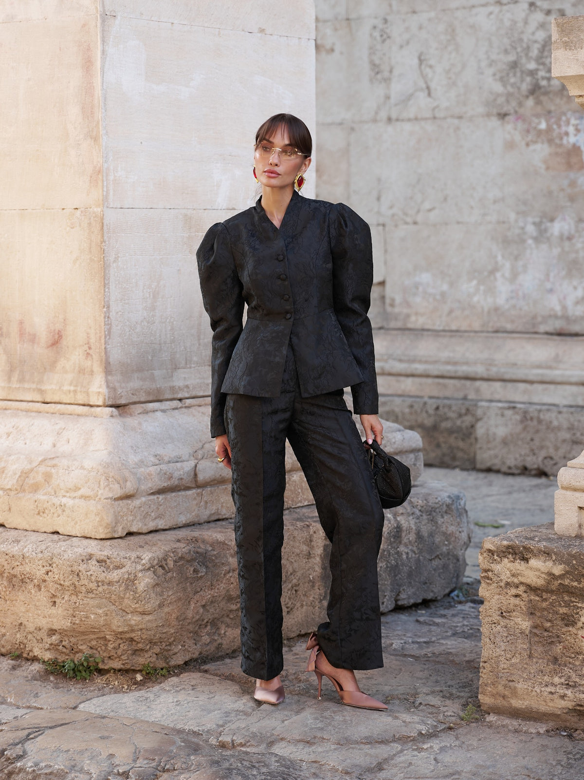 Black jacquard suit with puff-shoulder blazer and matching trousers, full front view