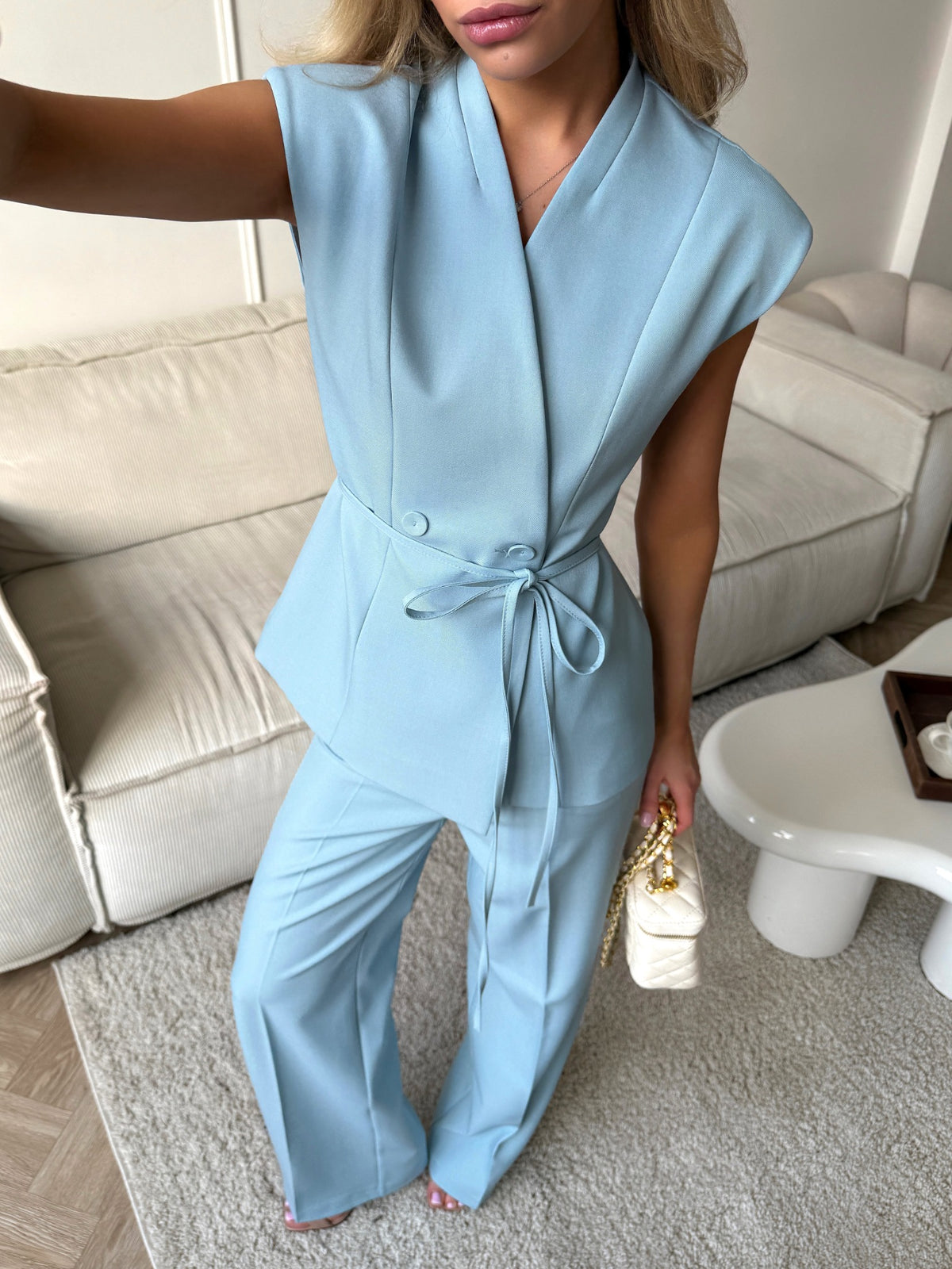 Powder blue wrap top — angled detail view